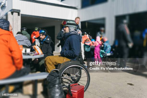 friends having lunch outside ski lodge - disabled skier stock pictures, royalty-free photos & images