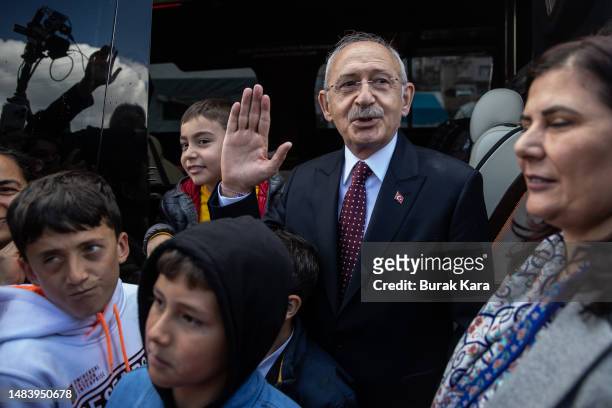 Republican People's Party leader and the presidential candidate of the main opposition alliance Kemal Kilicdaroglu waves as he chats with kids while...