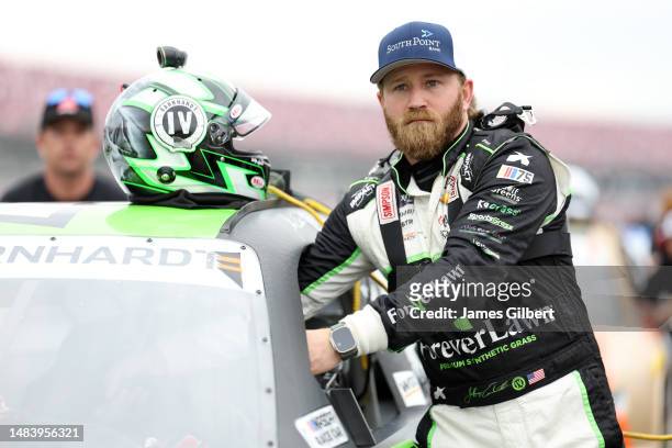 Jeffrey Earnhardt, driver of the SouthPoint Bank/ForeverLawn Chevrolet, and crew push his car on the grid during qualifying for the NASCAR Xfinity...