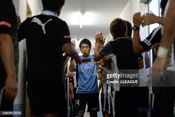 Kengo Nakamura of Kawasaki Frontale high fives with teammates and staffs in the tunnel prior to the J.League J1 match between Kawasaki Frontale and...