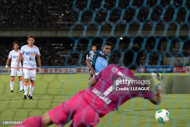 Renato Ribeiro Calixto of Kawasaki Frontale takes a penalty saved by Shusaku Nishikawa of Sanfrecce Hiroshima during the J.League J1 match between...