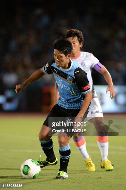 Yusuke Igawa of Kawasaki Frontale controls the ball against Hisato Sato of Sanfrecce Hiroshima during the J.League J1 match between Kawasaki Frontale...