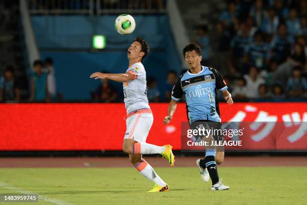 Takuma Asano of Sanfrecce Hiroshima controls the ball against Yuki Saneto of Kawasaki Frontale during the J.League J1 match between Kawasaki Frontale...