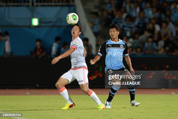 Takuma Asano of Sanfrecce Hiroshima controls the ball against Yuki Saneto of Kawasaki Frontale during the J.League J1 match between Kawasaki Frontale...