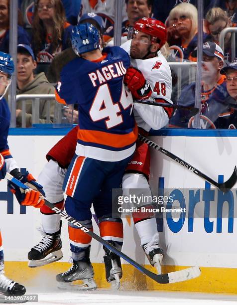 Jean-Gabriel Pageau of the New York Islanders hits Jordan Martinook of the Carolina Hurricanes during the first period in Game Three in the First...