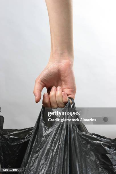 hand, woman's hand, plastic bag, garbage, carry, back view - reusable bag isolated stock pictures, royalty-free photos & images