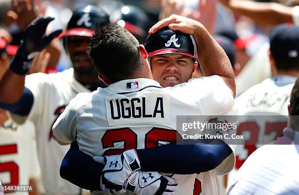 Freddie Freeman of the Atlanta Braves celebrates with Dan Uggla after hitting a three-run homer in the fifth inning against the New York Mets at...