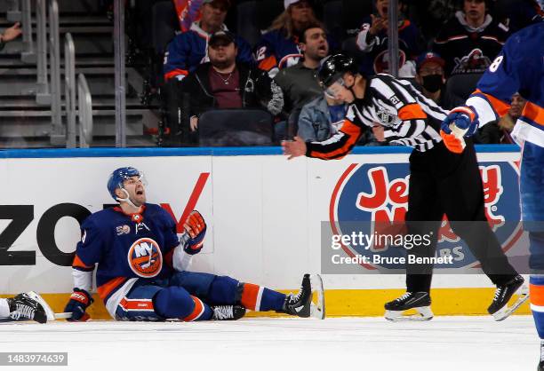 Adam Pelech of the New York Islanders argues a second period tripping call with referee TJ Luxmore during the game against the Carolina Hurricanes in...