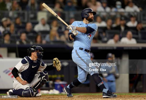 Brandon Belt of the Toronto Blue Jays hits a 2 RBI double to right field as Kyle Higashioka of the New York Yankees defends in the eighth inning at...