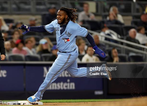 Vladimir Guerrero Jr. #27 of the Toronto Blue Jays rounds third and scores off a double from teammate Brandon Belt in the eighth inning against the...