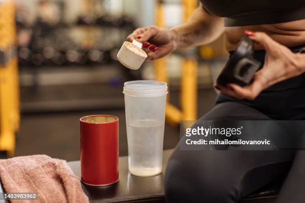 preparing a protein shake - protein stock pictures, royalty-free photos & images