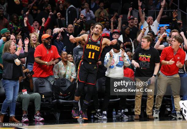 Trae Young of the Atlanta Hawks reacts after hitting a three-point basket against the Boston Celtics during the fourth quarter of Game Three of the...