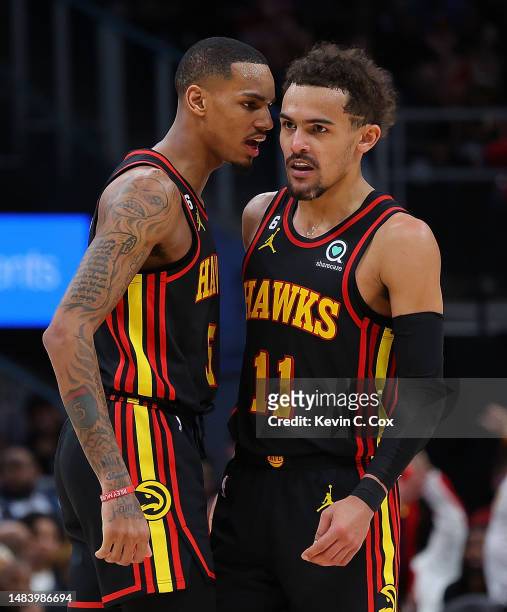 Trae Young of the Atlanta Hawks reacts after hitting a three-point basket against the Boston Celtics with Dejounte Murray during the fourth quarter...