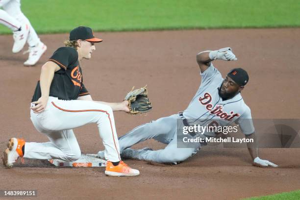 Akil Baddoo of the Detroit Tigers steals second base Gunnar Henderson of the Baltimore Orioles in the ninth inning during a baseball game against the...