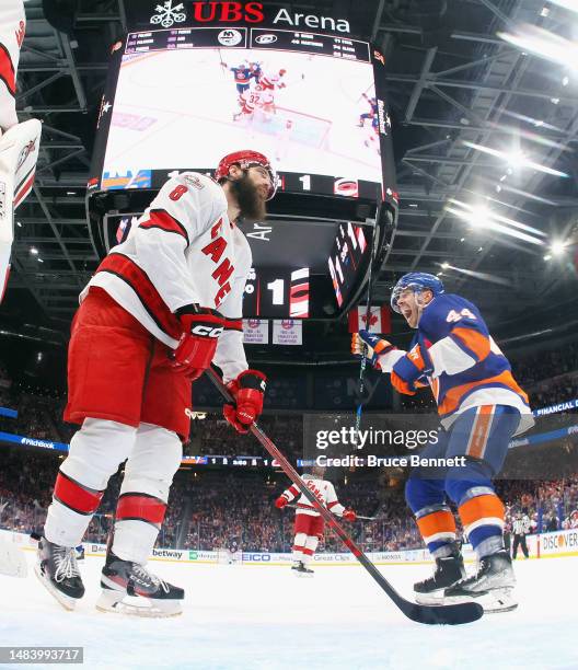 Jean-Gabriel Pageau of the New York Islanders celebrates the game-winning goal by Kyle Palmieri against Brent Burns and the Carolina Hurricanes...