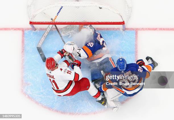 Jordan Staal of the Carolina Hurricanes crashes the net as Jesper Fast scores a second period goal against Ilya Sorokin of the New York Islanders...