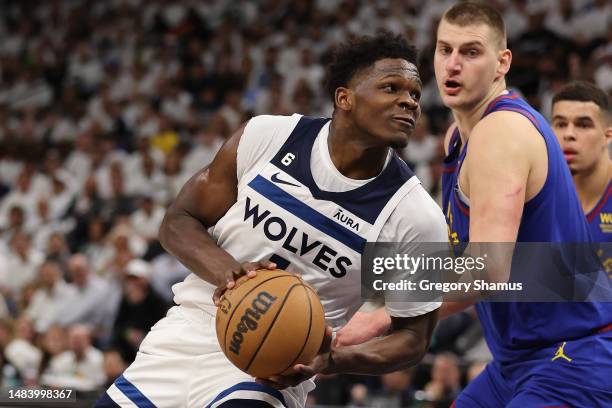 Anthony Edwards of the Minnesota Timberwolves drives around Nikola Jokic of the Denver Nuggets during the first half in Game Three of the Western...