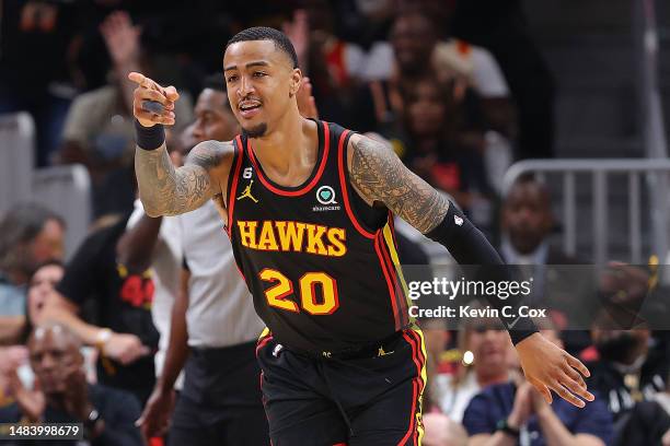 John Collins of the Atlanta Hawks reacts after hitting a three-point basket against the Boston Celtics during the second quarter of Game Three of the...