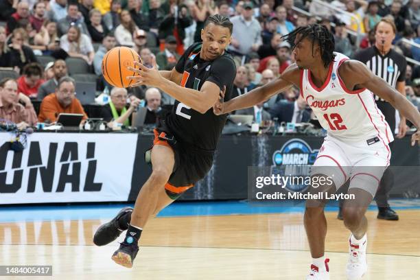 Isaiah Wong of the Miami Hurricanes drives to the basket by Tramon Mark of the Houston Cougars during the Sweet 16 round of the NCAA Men's Basketball...