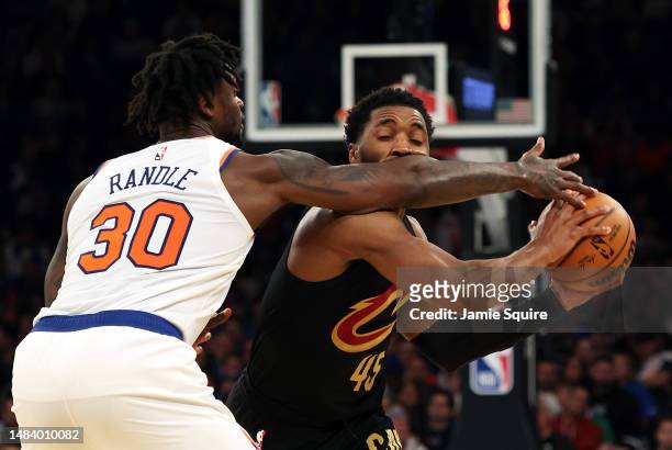 Donovan Mitchell of the Cleveland Cavaliers is fouled by Julius Randle of the New York Knicks during game three of the Eastern Conference playoffs at...