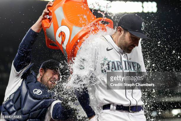 Tom Murphy douses AJ Pollock of the Seattle Mariners with water after beating the St. Louis Cardinals 5-2 at T-Mobile Park on April 21, 2023 in...