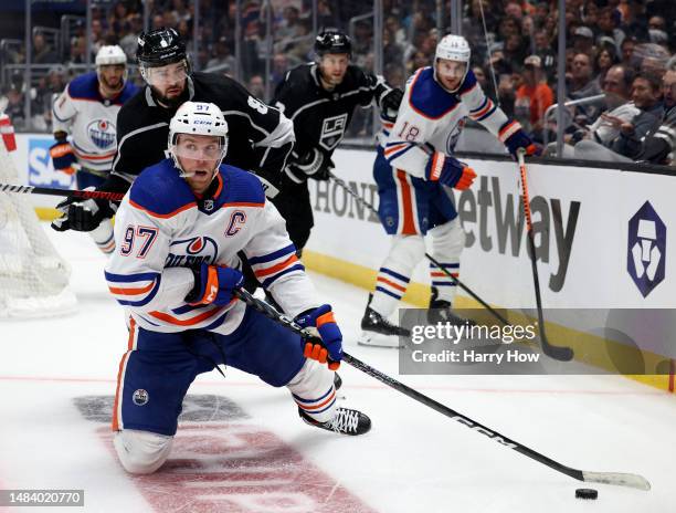 Connor McDavid of the Edmonton Oilers plays the puck form a knee in front of Drew Doughty of the Los Angeles Kings during the third period in Game...