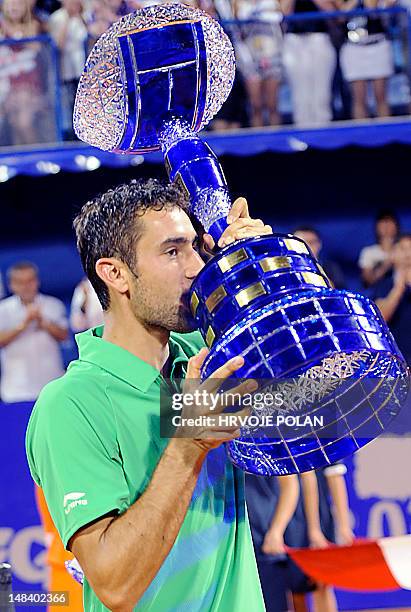 Marin Cilic of Croatia kisses his trophy as he celebrates his victory over Marcel Granollers of Spain at the end of the ATP Croatia Open tennis...
