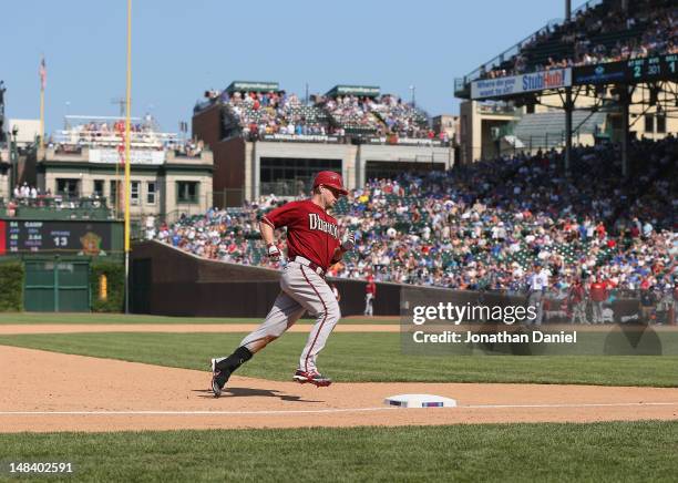Aaron Hill of the Arizona Diamondbacks runs the bases after hitting a solo home run in the top of the 8th inning against the Chicago Cubs at Wrigley...