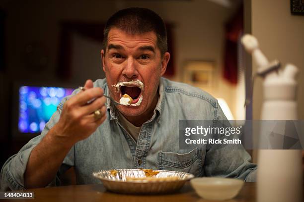 whipped cream - man eating pie stock pictures, royalty-free photos & images