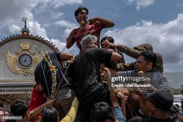 Javanese people jostle for the 'Gunungan', a sacrifice in the shape of a mountain, during the Grebeg Syawalan ceremony as part of celebrations for...