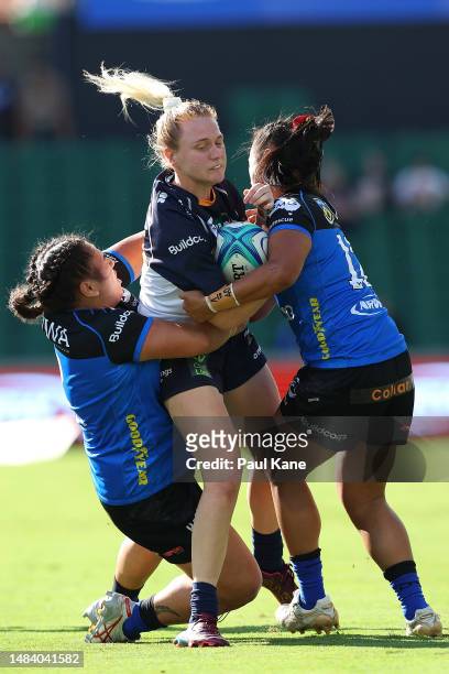 Ashlea Bishop of the Brumbies gets tackled by Hera-Barb Malcolm Heke and Trilleen Pomare of the Force during the Super W match between Western Force...