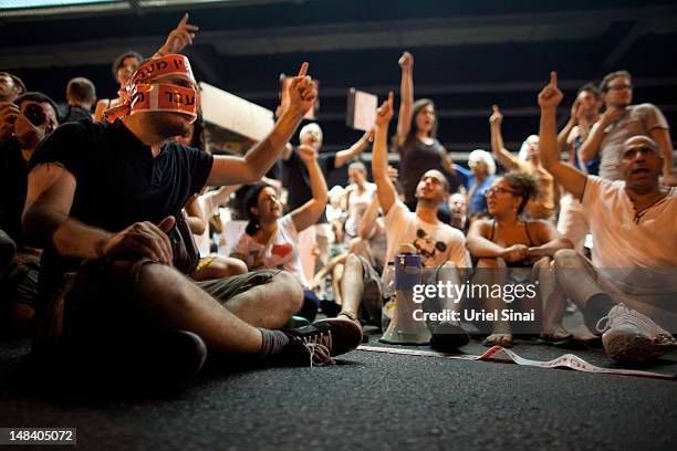 Israelis block a highway as they march through the streets to protest rising housing costs on July 15, 2012 in Tel Aviv, Israel. Growing discontent...