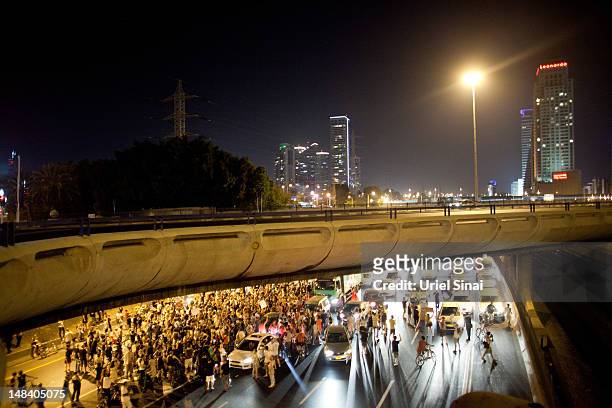 Israelis block a highway as they march through the streets to protest rising housing costs on July 15, 2012 in Tel Aviv, Israel. Growing discontent...