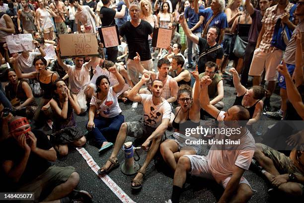 Israelis block a highway as they march through the streets to protest rising housing costs on July 15, 2012 in Tel Aviv, Israel. Growing discontent...