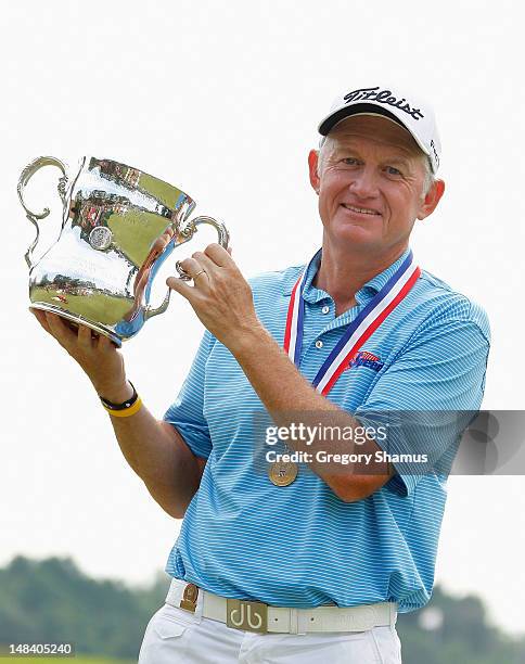 Roger Chapman of England holds up the Francis D. Ouimet Memorial Trophy after winning the 2012 Senior United States Open at Indianwood Golf and...