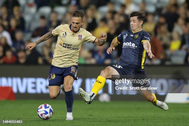 Reno Piscopo of the Jets is tackled by Harry Steele of the Mariners during the round 25 A-League Men's match between Newcastle Jets and Central Coast...