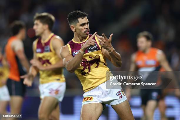 Charlie Cameron of the Lions celebrates kicking a goal by counting them on his fingers during the round six AFL match between Greater Western Sydney...