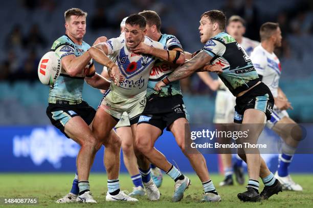 Braidon Burns of the Bulldogs offloads the ball during the round eight NRL match between Canterbury Bulldogs and Cronulla Sharks at Accor Stadium on...