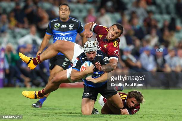 Hamish Stewart of the Force gets tackled by Thomas Umaga-Jensen and James Arscott of the Highlanders during the round nine Super Rugby Pacific match...
