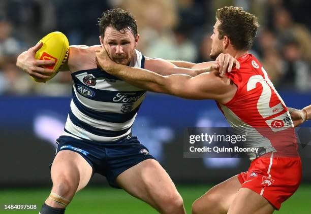 Patrick Dangerfield of the Cats is tackled by Luke Parker of the Swans during the round six AFL match between Geelong Cats and Sydney Swans at GMHBA...