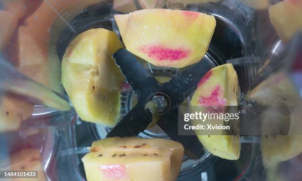 kiwi fruit under high speed blending synced in high speed photography - flying kiwi stock pictures, royalty-free photos & images