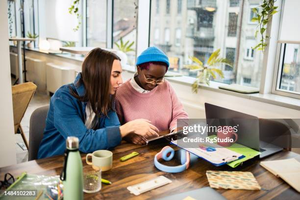 three young colleagues cooperating on their work - androgynous stock pictures, royalty-free photos & images