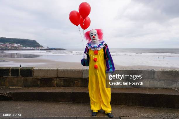 Man dressed as Pennywise the clown from the book and movie IT poses for pictures as he attends on the first day of the Scarborough Sci-Fi weekend on...