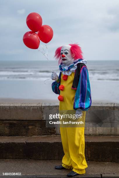 Man dressed as Pennywise the clown from the book and movie IT poses for pictures as he attends on the first day of the Scarborough Sci-Fi weekend on...