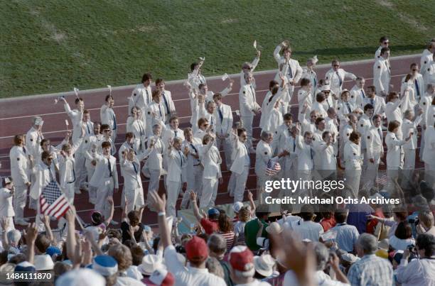 Athletes wearing white suits as they participate in the opening ceremony of the 1984 Summer Olympics, held at the Los Angeles Memorial Coliseum in...