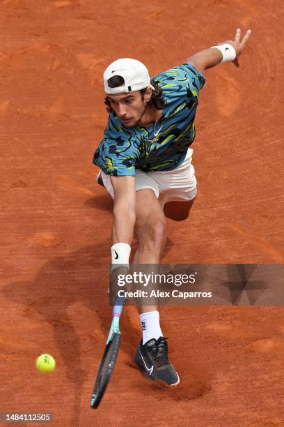 Lorenzo Musetti of Italy plays a backhand against Stefanos Tsitsipas of Greece during the semi-final match on day six of the Barcelona Open Banc...