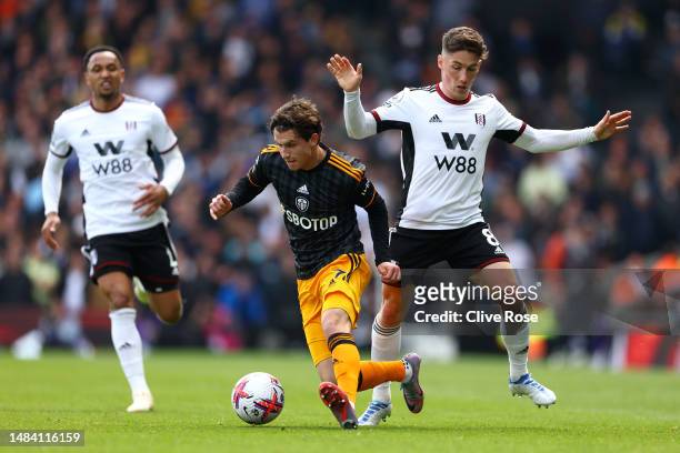 Brenden Aaronson of Leeds United is challenged by Harry Wilson of Fulham during the Premier League match between Fulham FC and Leeds United at Craven...
