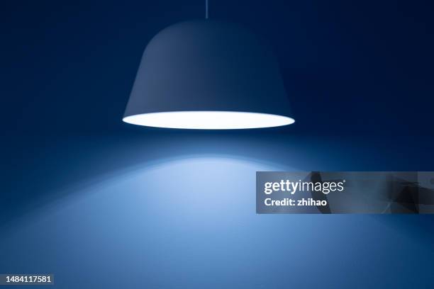 electric light in front of blue wall - fitting stockfoto's en -beelden