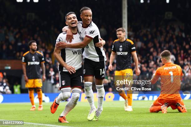 Andreas Pereira of Fulham celebrates with teammate Bobby Reid after scoring the team's second goal during the Premier League match between Fulham FC...