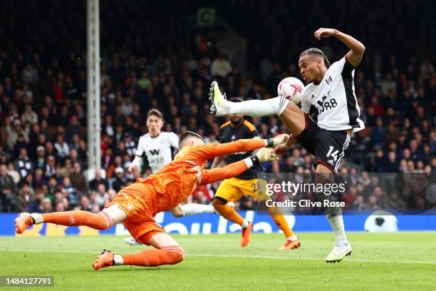 Illan Meslier of Leeds United makes a save whilst under pressure from Bobby Reid of Fulham during the Premier League match between Fulham FC and...